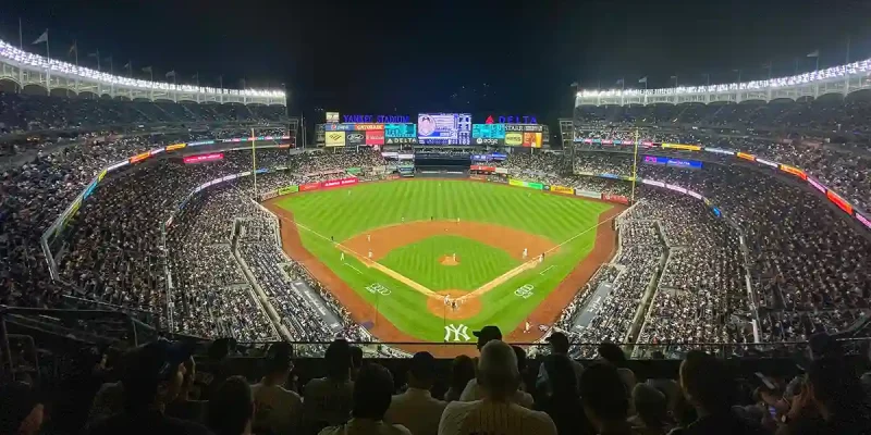 Yankee Stadium in the Bronx at night (photo credit: Andrew nyr CC-BY-SA-4.0 via Wikimedia Commons)