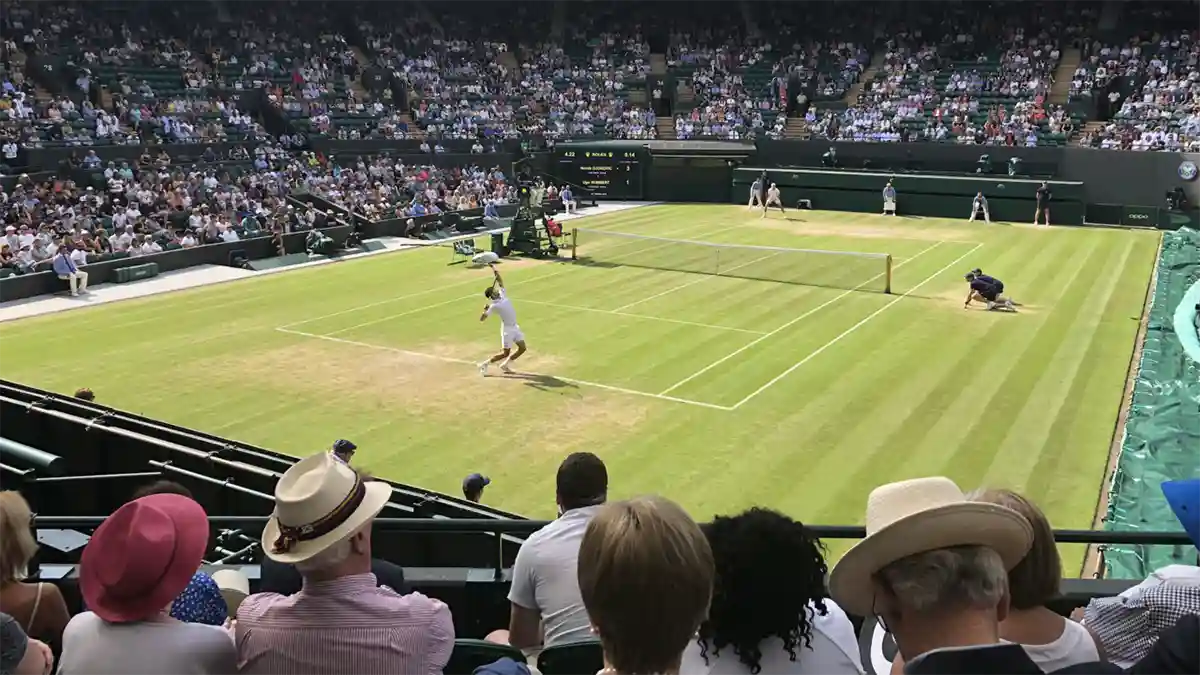 Fans watch the Wimbledon tournament in progress in 2019. (Photo: LHC88, CC BY 4.0, via Wikimedia Commons)