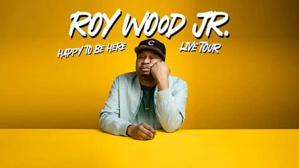 Roy Wood jr Happy to be Here tour image roy wood sitting behind a yellow table