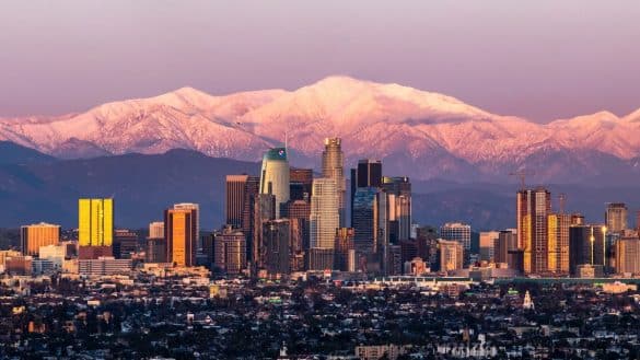February shot of downtown Los Angeles sunset with Mount Baldy in the background after a large snow storm | Photo by Alex Leckszas via Wikimedia Commons