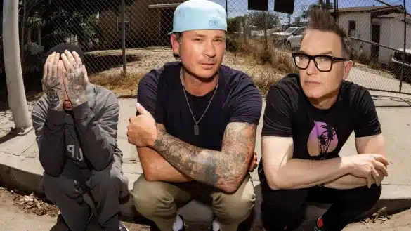 Blink-182 members Mark Hoppus, Tom DeLonge and Travis Barker pose together | Photo by Sony Music Entertainment Sweden via Wikimedia Commons