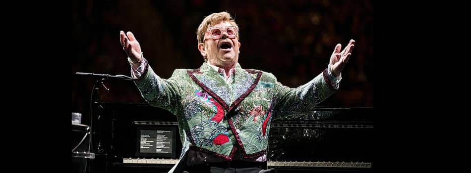 Elton John at a piano